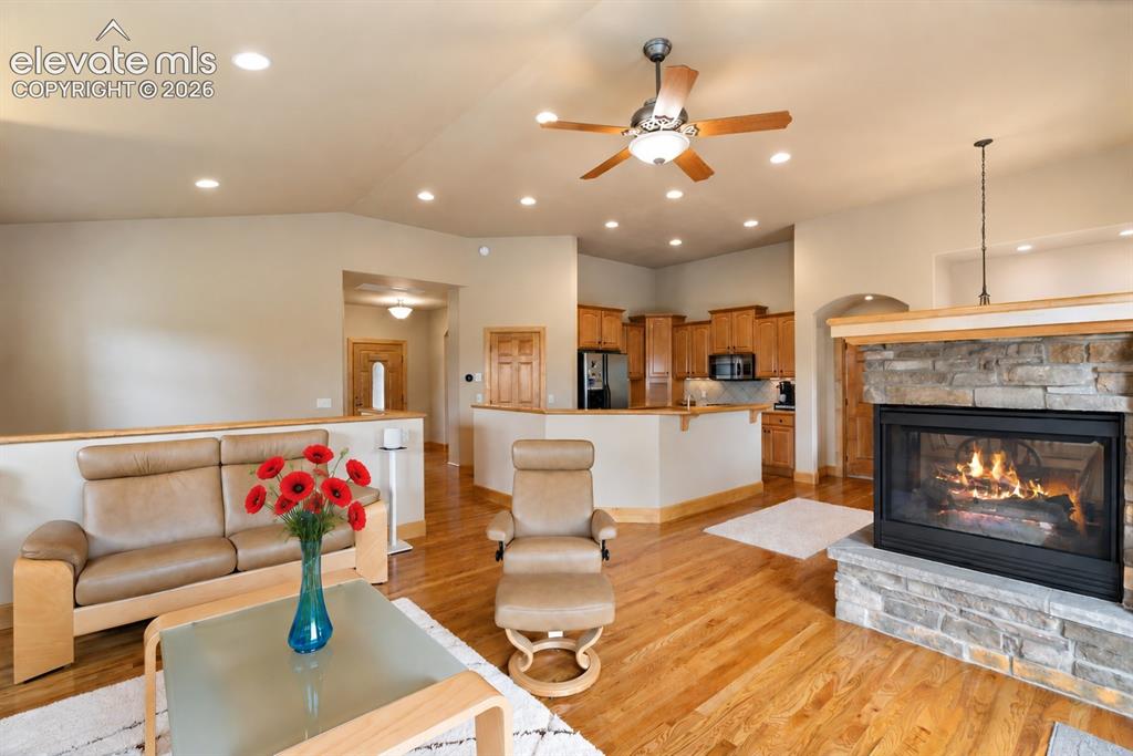 Image 4 of 24: Living room, gas tri-sided fireplace and walk out. 