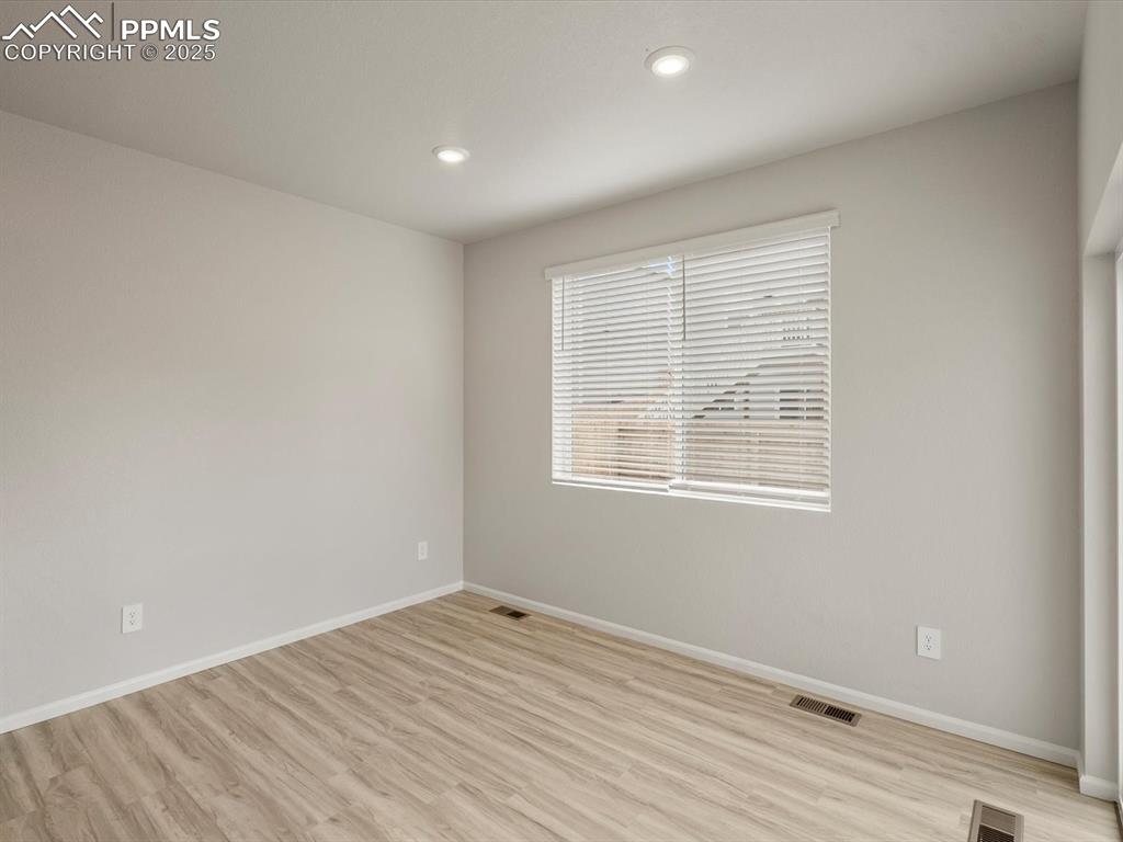 Image 10 of 30: Spare room featuring light wood finished floors and recessed lighting