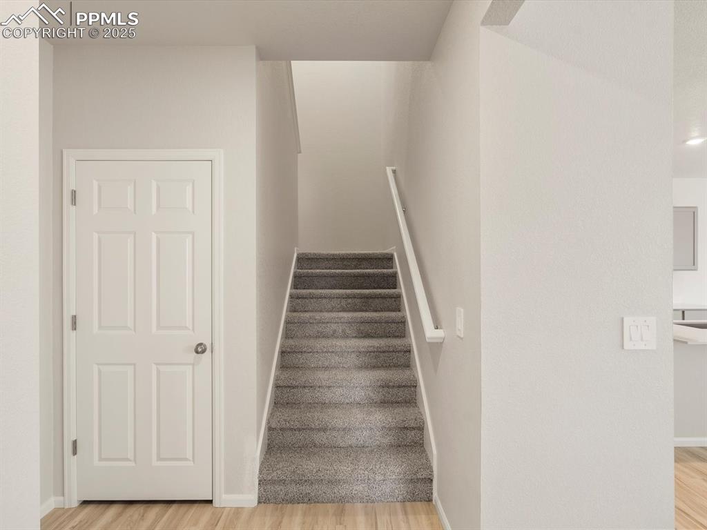 Image 12 of 30: Staircase with wood finished floors and baseboards