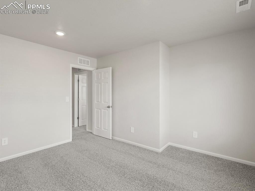 Image 17 of 30: Carpeted empty room with baseboards and recessed lighting