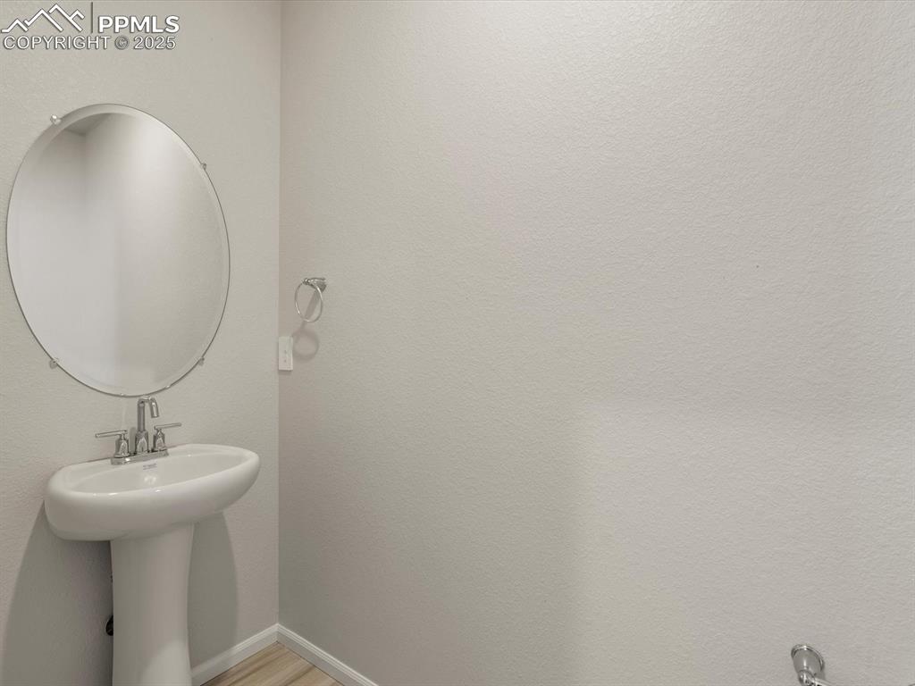 Image 3 of 30: Bathroom featuring light wood finished floors and a textured wall