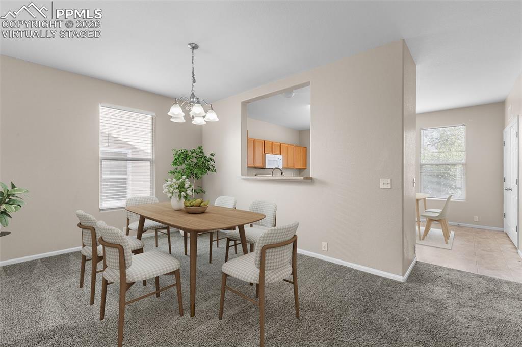 Image 10 of 38: *Virtually Staged* Dining room featuring light carpet, plenty of natural li