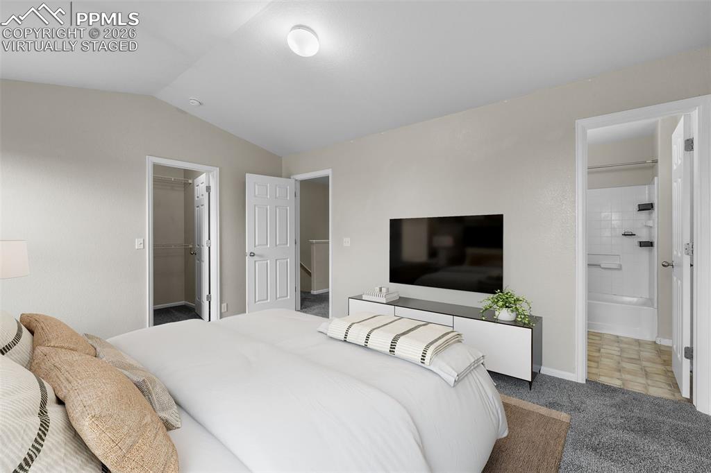 Image 21 of 38: *Virtually Staged* Bedroom featuring carpet flooring, lofted ceiling, a spa