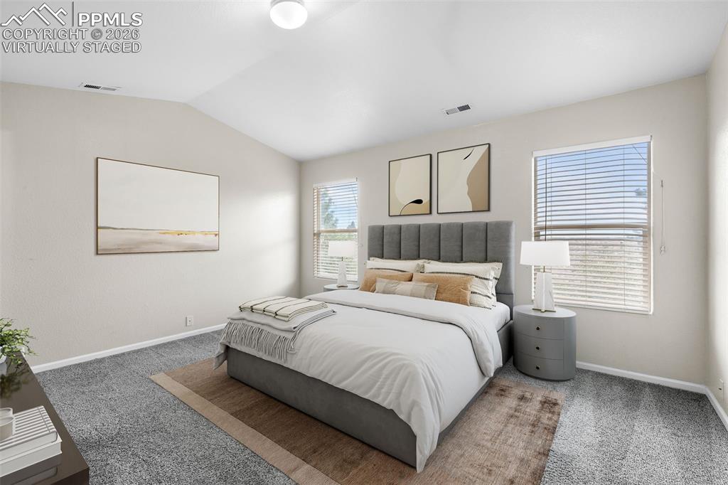 Image 23 of 38: *Virtually Staged* Bedroom with light carpet and lofted ceiling