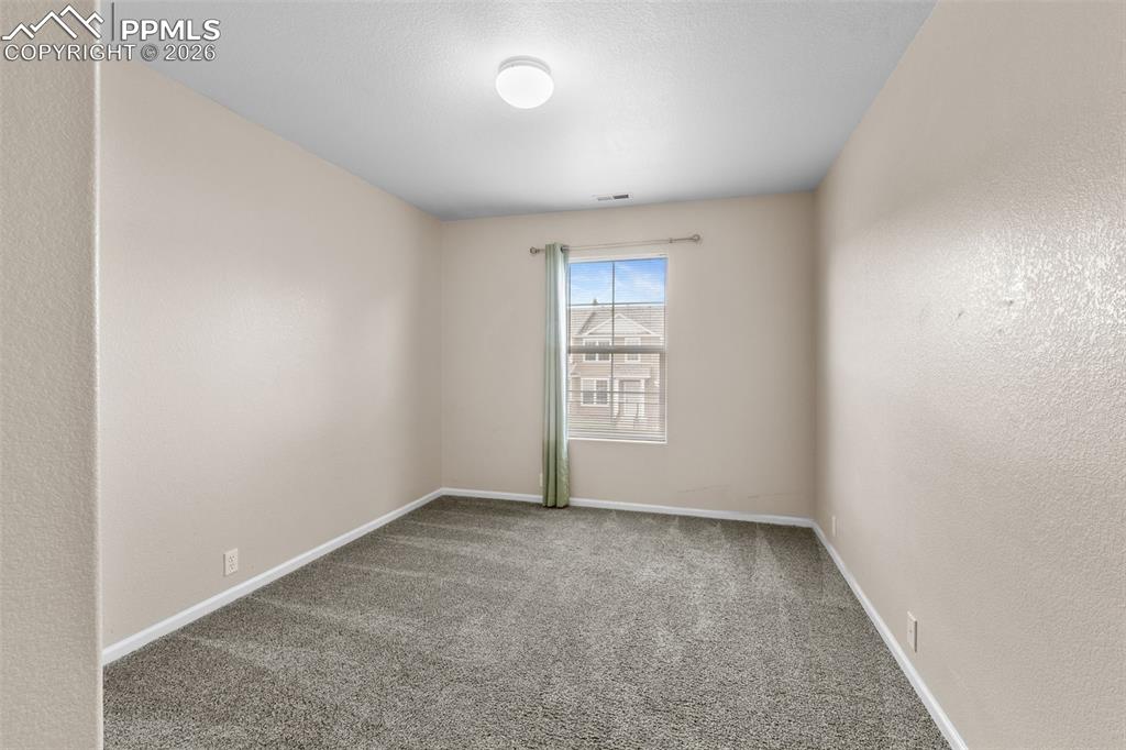 Image 27 of 38: Carpeted empty room with a textured wall