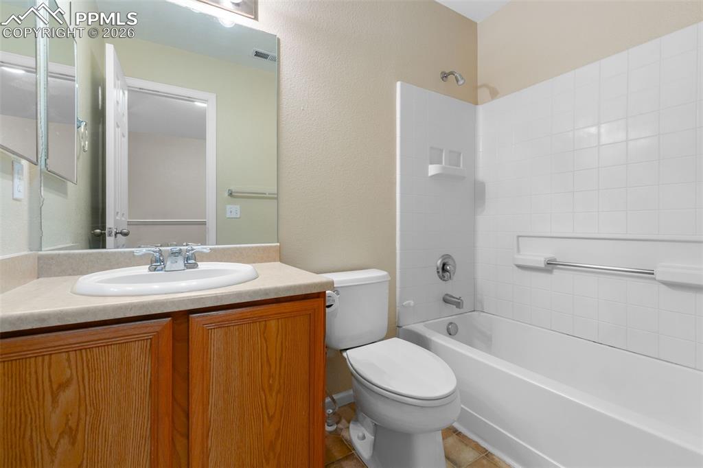 Image 30 of 38: Full bath with shower combination and vanity