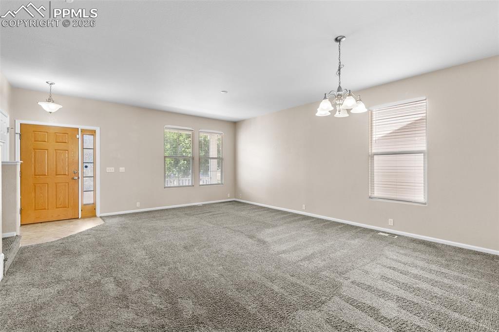 Image 5 of 38: Unfurnished Dining room featuring carpet and a chandelier