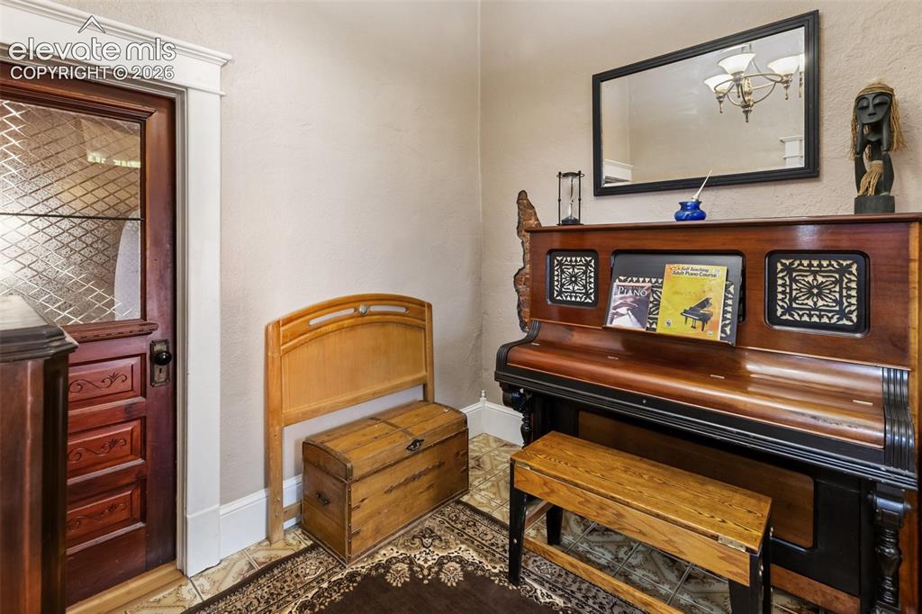 Image 12 of 43: another view of the Foyer or Piano Room. You can the window in the door int