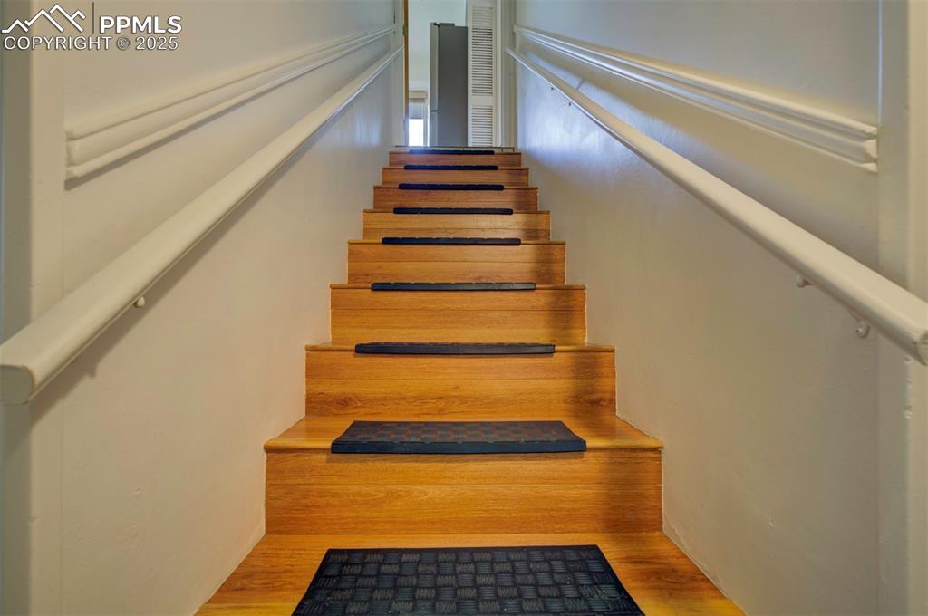 Image 37 of 49: Stairs with wood finished floors