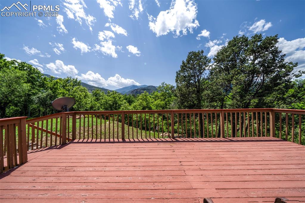Image 4 of 49: Wooden deck featuring a mountain view