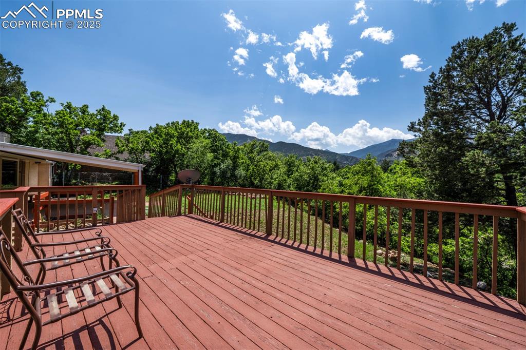 Image 43 of 49: Wooden terrace featuring a mountain view