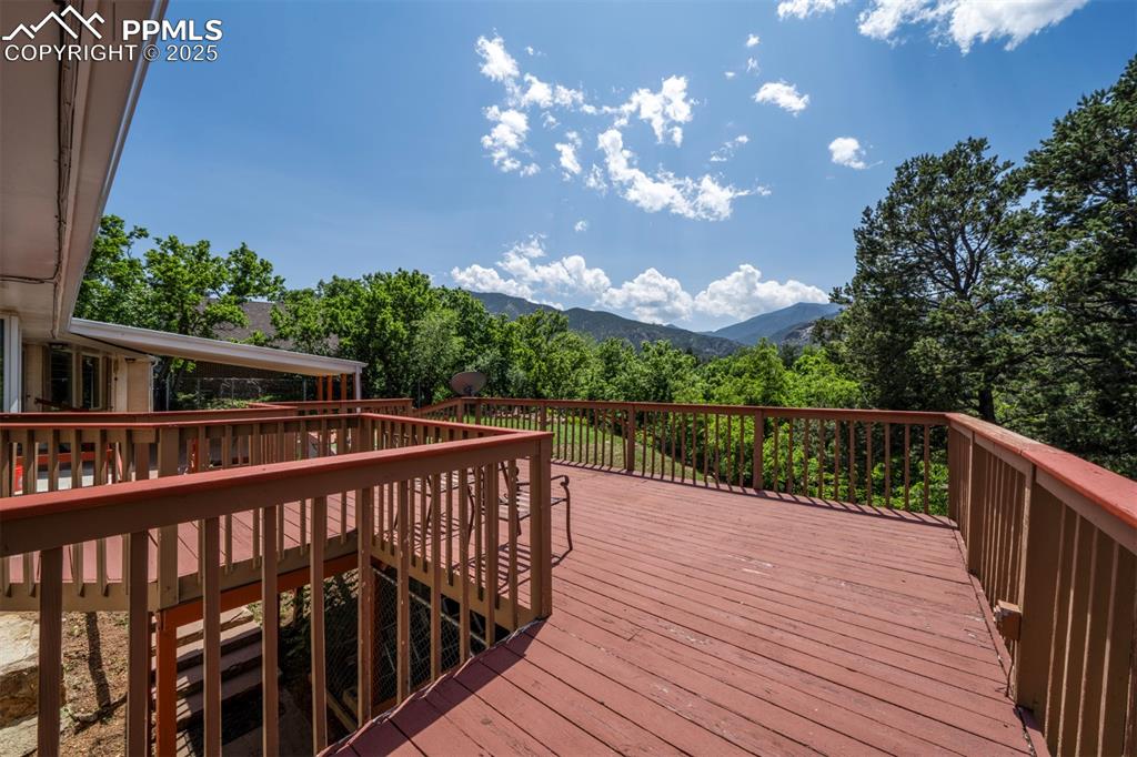Image 44 of 49: Wooden terrace with a mountain view