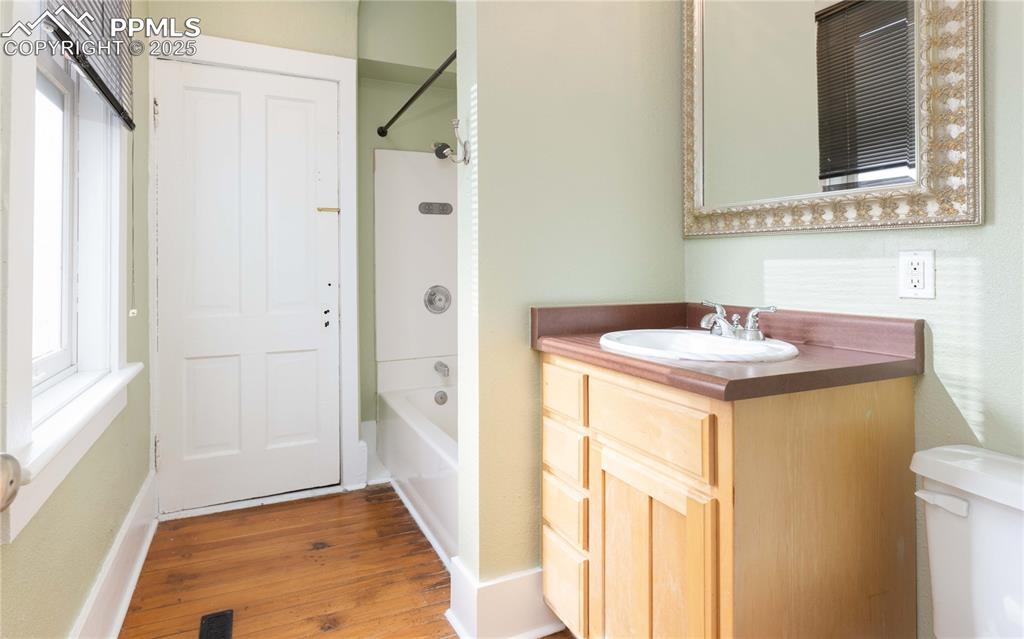 Image 13 of 31: Bathroom with vanity, bathing tub / shower combination, light wood-style fl
