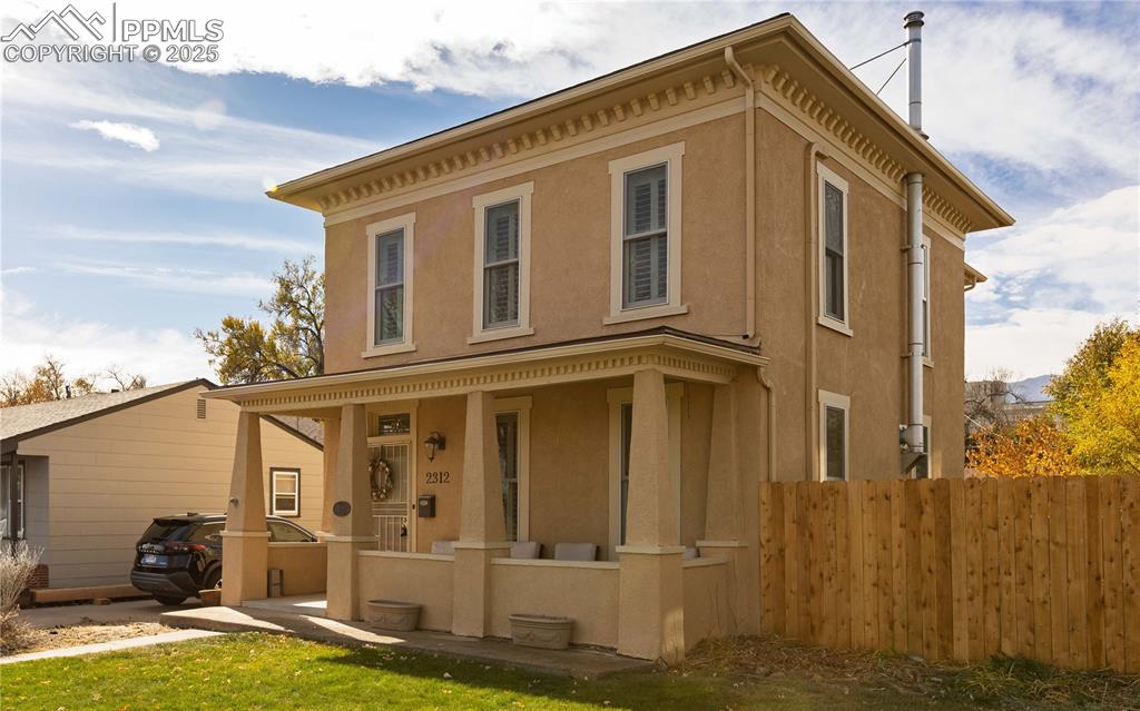 Image 2 of 31: View of front of house featuring a porch and stucco siding
