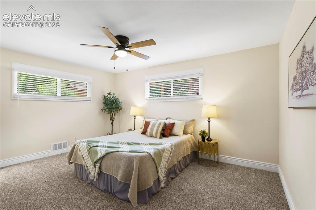 Image 10 of 36: Neutral-toned walls complement plush carpeting throughout