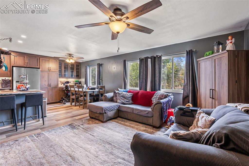 Image 17 of 50: Living area with light wood-style floors