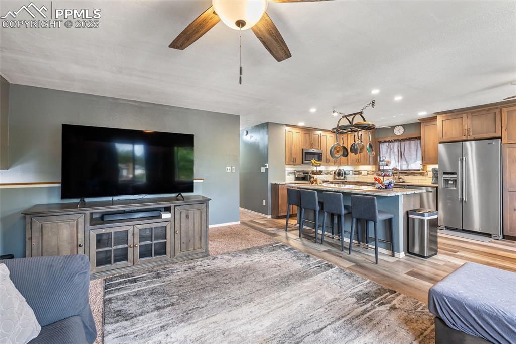 Image 19 of 50: Living room featuring recessed lighting, light wood finished floors, and ce