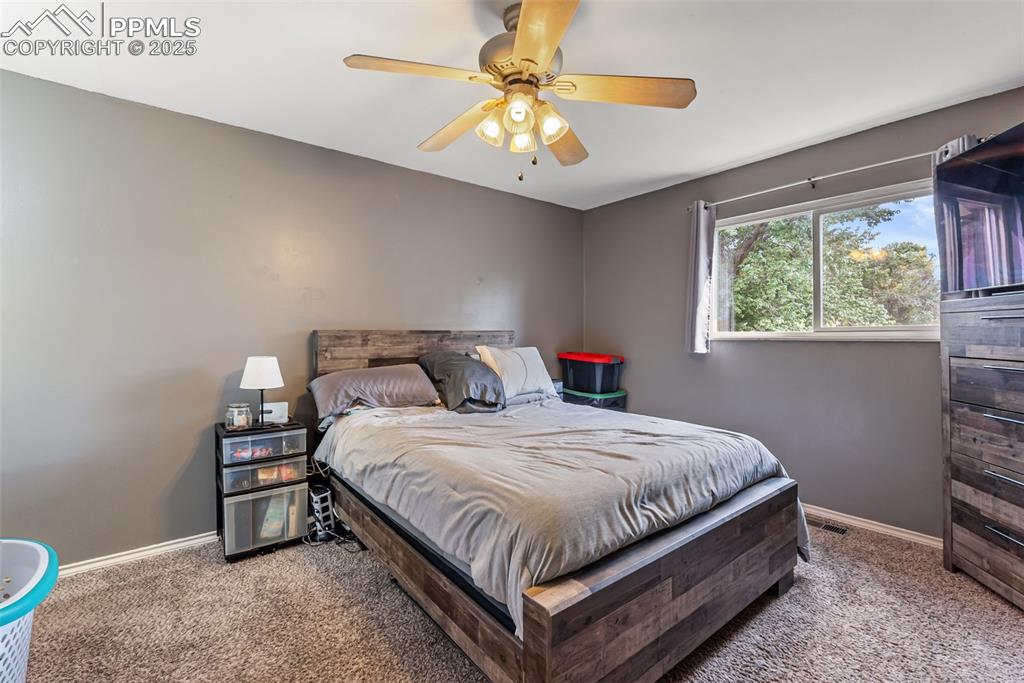 Image 20 of 50: Carpeted bedroom featuring baseboards and ceiling fan