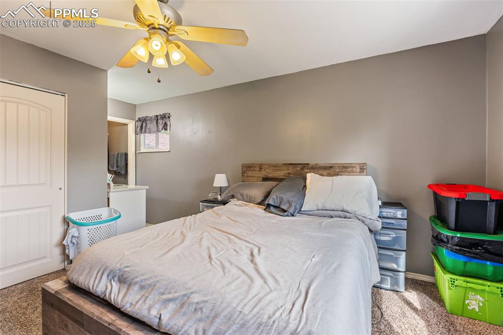 Image 21 of 50: Carpeted bedroom featuring a closet and ceiling fan