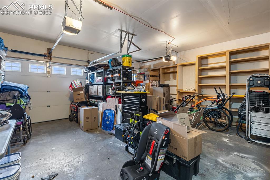 Image 43 of 50: Garage featuring a garage door opener