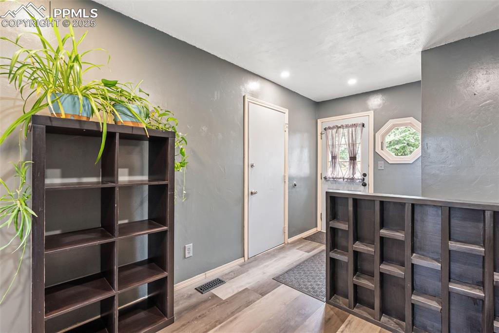 Image 8 of 50: Reception with recessed lighting and a textured wall