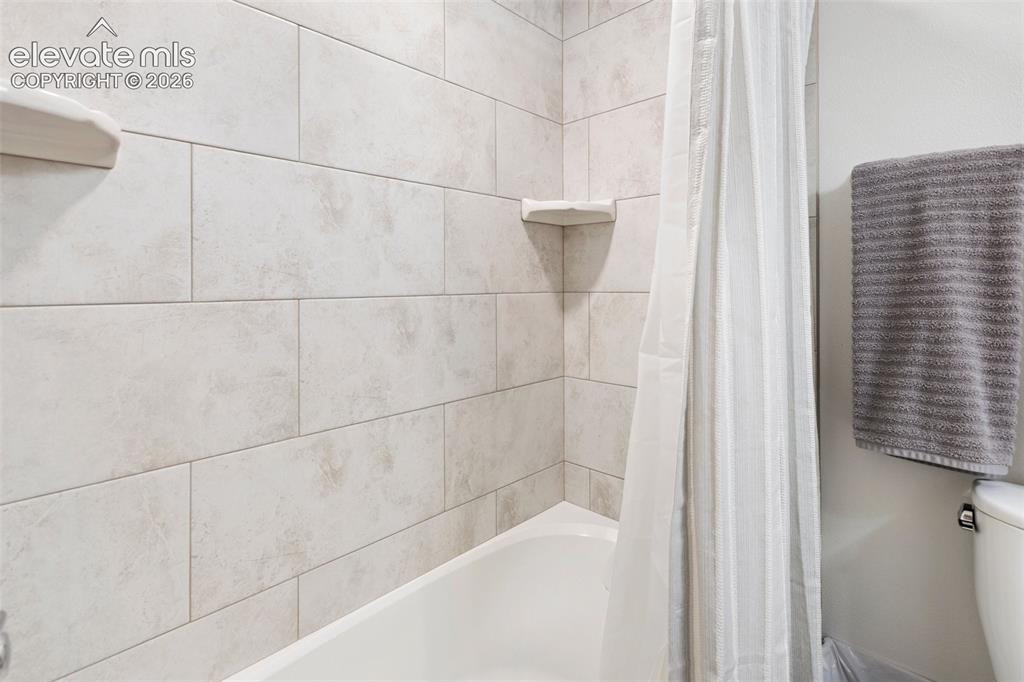 Image 21 of 29: Primary bathroom, accessible shower.