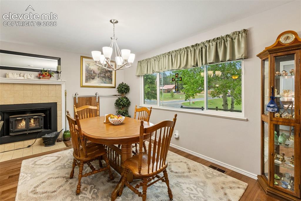 Image 8 of 29: Living room and woodburning fireplace