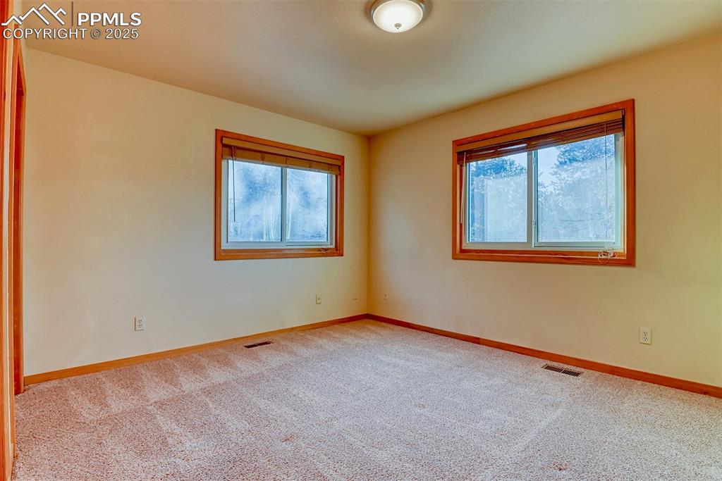 Image 11 of 23: One of two large main-level bedrooms