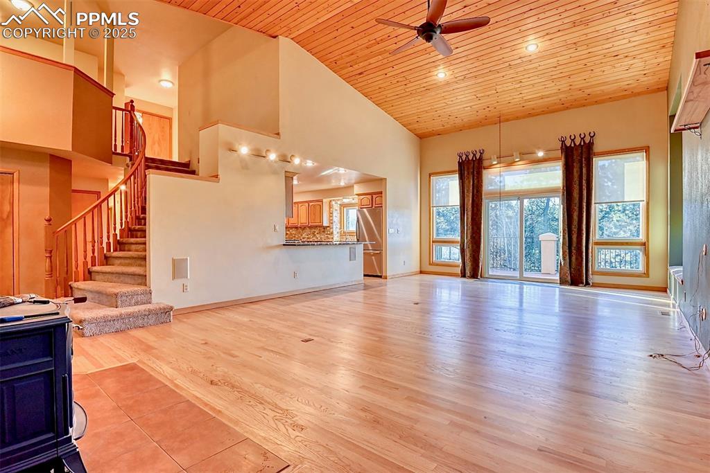 Image 2 of 23: The great room featuring real hardwood flooring, a Vermont Castings wood bu