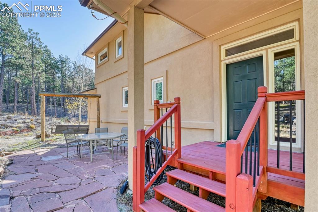 Image 23 of 23: Northside patios for shade on the flag stone patio and the Leo seat swing.