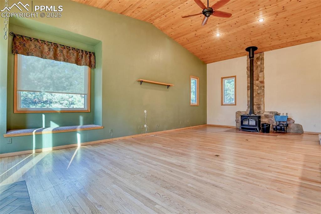 Image 3 of 23: A window seat great for reading, the wood burning stove will keep you warm