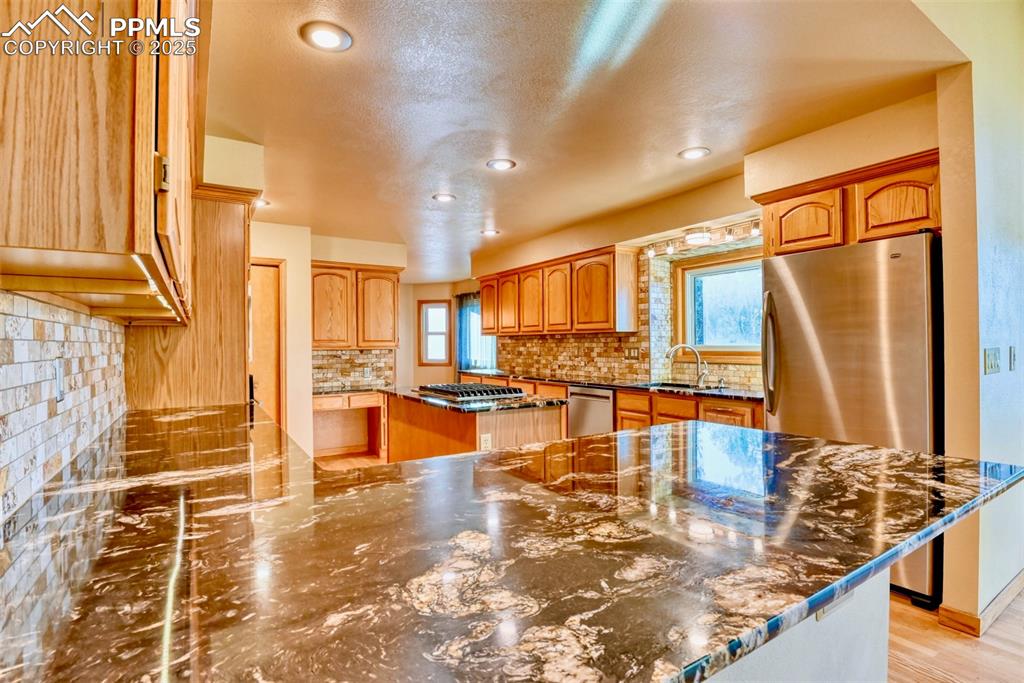 Image 4 of 23: Titanium Granite countertops with a meticulously crafted backsplash