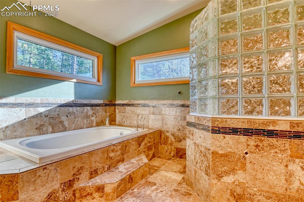 Image 8 of 23: Large soaking tub and the walk-in shower