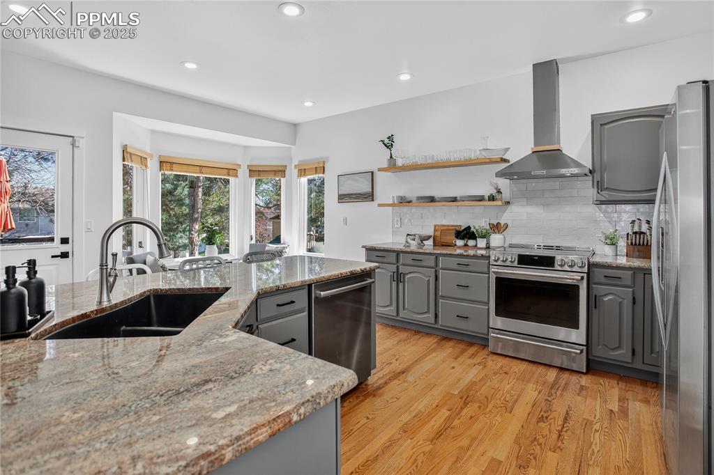 Image 14 of 47: Spacious with refreshed cabinets, tile backsplash, Cafe range oven in 2024.