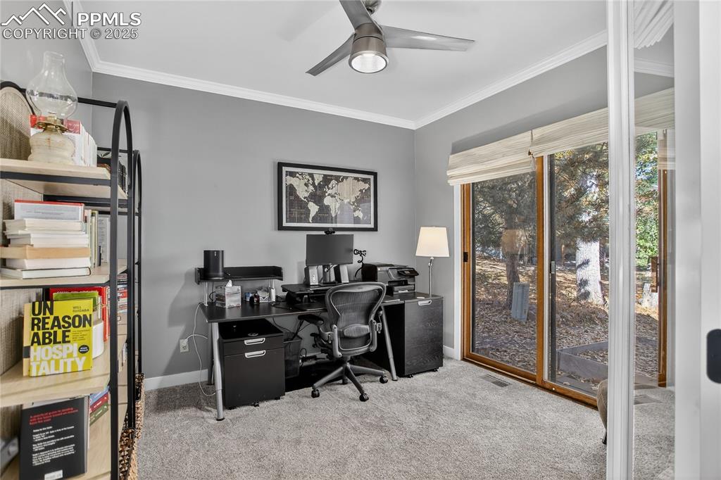 Image 22 of 47: The main level glass enclosed office has new library doors, walks out to th