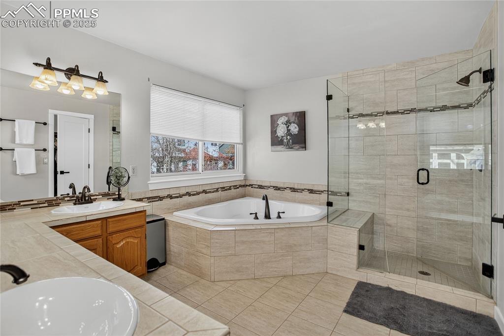 Image 30 of 47: Primary 5 piece ensuite bath, tile, granite updated backsplash, walkin clo