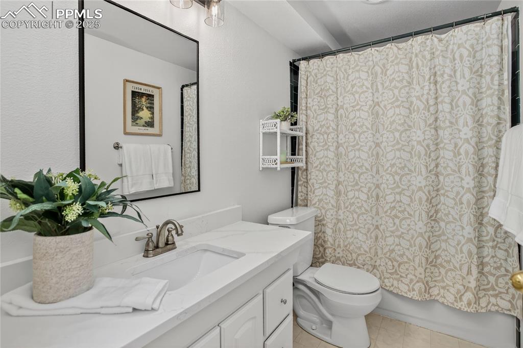 Image 35 of 47: Downstairs full bath has tasteful new granite counter top, lighting and har