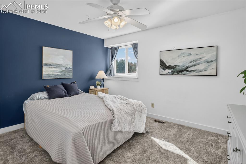 Image 36 of 47: Third bedroom on 2nd level with new paint, trim, carpet and ceiling fan.