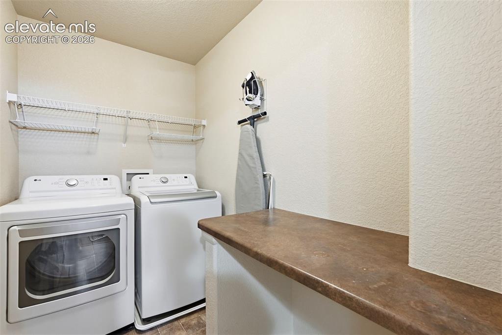 Image 20 of 33: Upstairs Laundry with Folding Counter