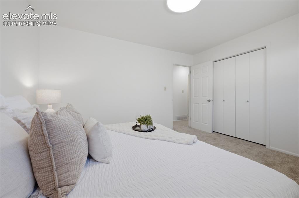 Image 21 of 34: White walls, white trim, and a white interior door