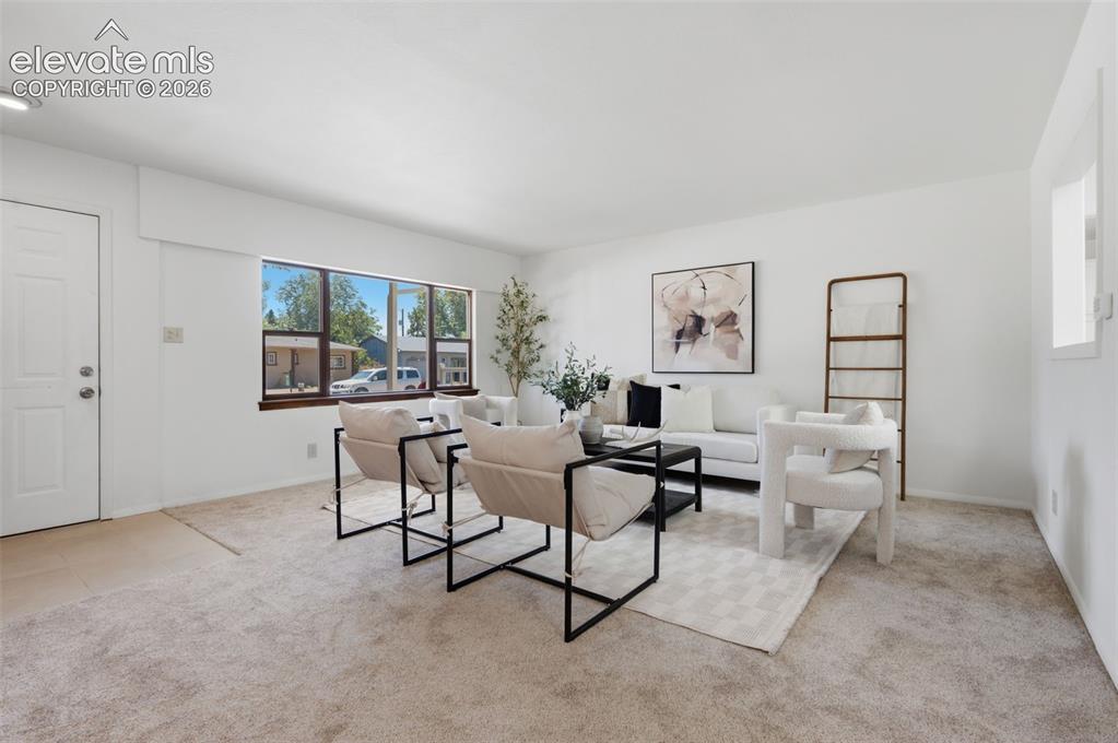 Image 5 of 34: Bright, open floor plan with expansive carpet flooring throughout
