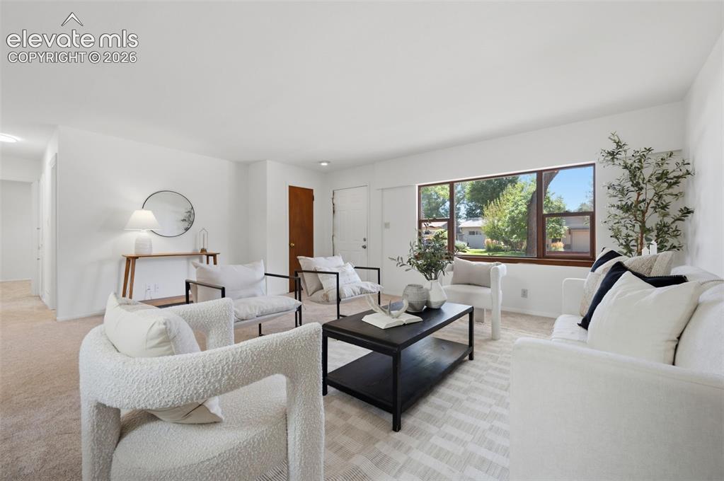 Image 6 of 34: Expansive window with wood-finish trim, neutral wall color, and light-toned