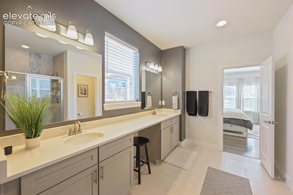 Image 24 of 45: Dual vanity with light countertops and undermount sinks