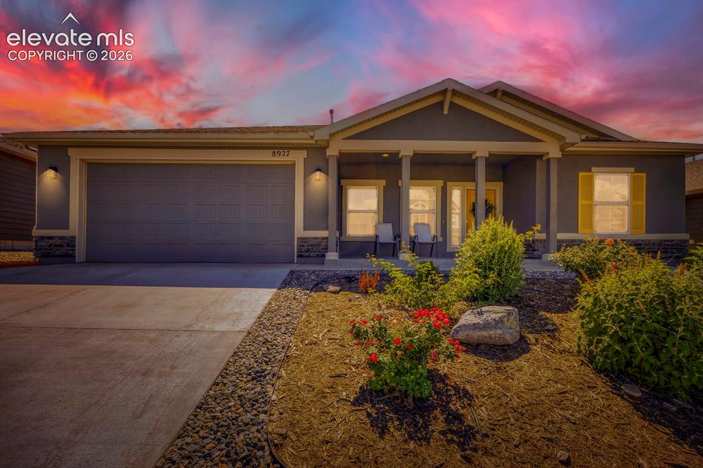 Image 39 of 45: Contemporary stucco exterior featuring a covered front porch with column de