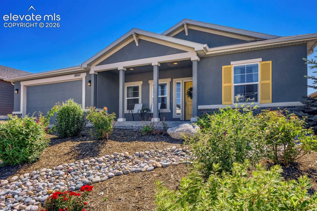 Image 6 of 45: Contemporary single-story residence featuring a covered front porch, an att