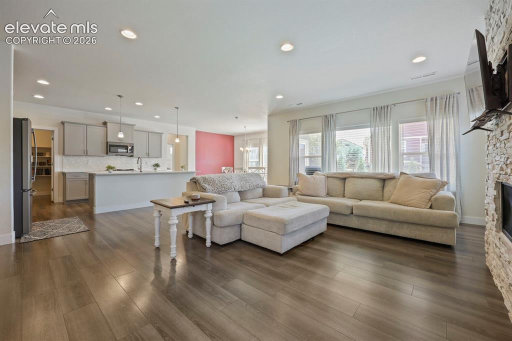 Image 9 of 45: Open-concept living space featuring wood-finish type flooring and recessed 