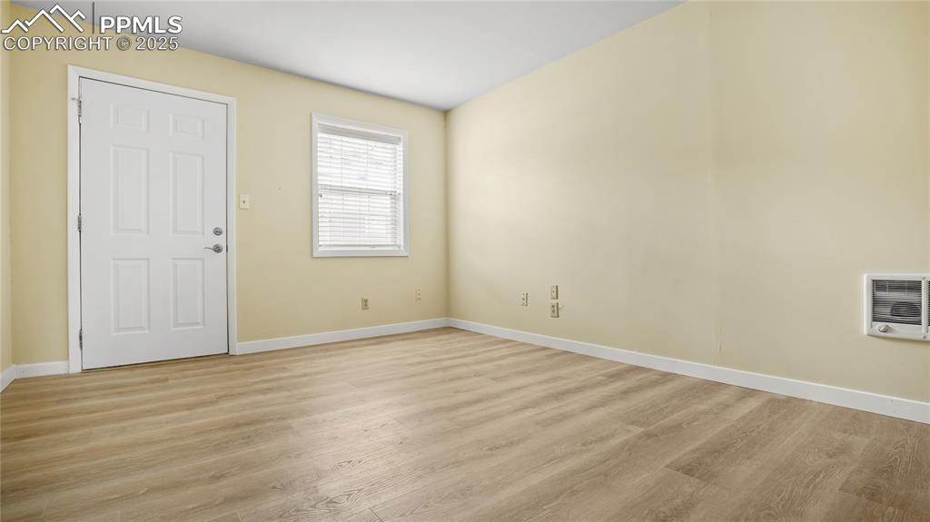 Image 10 of 25: Spare room featuring heating unit and light wood-type flooring