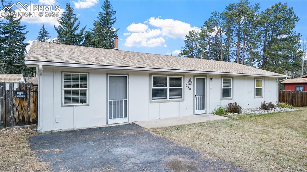 Image 2 of 25: Ranch-style house featuring roof with shingles and a patio area