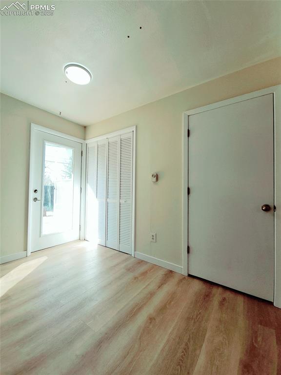Image 25 of 25: Unfurnished bedroom featuring light wood-type flooring, access to exterior,