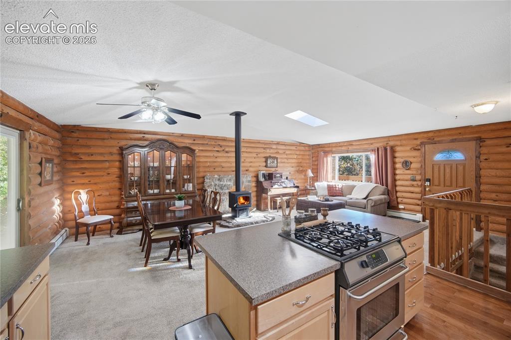 Image 11 of 34: Wood-paneled interior featuring a built-in range, wood-finish flooring, sky